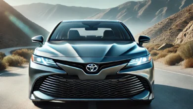 2025 Toyota Camry Hybrid with sleek design, LED headlights, and aerodynamic lines on a scenic road.