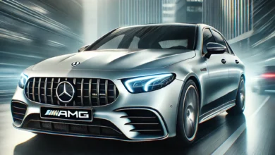 2025 Mercedes-AMG E53 sedan in motion with AMG grille and LED headlights.